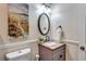 Elegant half-bathroom featuring a granite vanity, decorative mirror, and neutral tones, providing a stylish powder room at 3860 Overlake Dr, Cumming, GA 30041