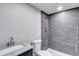 Bathroom with gray-tiled shower, hexagon tile floor, and granite-topped vanity offers a modern design at 3860 Overlake Dr, Cumming, GA 30041