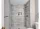 Modern bathroom with neutral colored tiles, shower and updated fixtures; natural light creates a relaxing atmosphere at 3860 Overlake Dr, Cumming, GA 30041