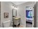 Bathroom featuring neutral tones, a modern vanity, and a stylish mirror beside the doorway to the bedroom at 3860 Overlake Dr, Cumming, GA 30041
