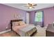 Bright bedroom with purple walls, carpet flooring, ceiling fan, and large window at 3860 Overlake Dr, Cumming, GA 30041