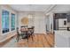 Bright dining area features wood floors, large windows, and stylish lighting at 3860 Overlake Dr, Cumming, GA 30041
