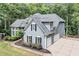Rear view of beautiful home featuring gray siding, an attached garage, and a wrap-around patio at 3860 Overlake Dr, Cumming, GA 30041