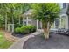 Charming home with a curved window facade, complemented by lush landscaping and a welcoming walkway at 3860 Overlake Dr, Cumming, GA 30041
