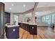 Open-concept kitchen with stainless steel appliances, adjacent to living and dining areas at 3860 Overlake Dr, Cumming, GA 30041