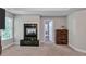 Comfortable living room with a fireplace and access to additional rooms at 3860 Overlake Dr, Cumming, GA 30041