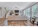 Bright living room featuring large windows, a fireplace, and hardwood floors at 3860 Overlake Dr, Cumming, GA 30041