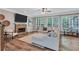 Inviting living room with fireplace, large windows, hardwood floors, and comfortable seating at 3860 Overlake Dr, Cumming, GA 30041
