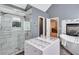 Stunning bathroom features a shower, tub next to a fireplace, and a large vanity with glass enclosed shelving at 3860 Overlake Dr, Cumming, GA 30041