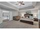 Spacious main bedroom features a seating area, carpet, and a tray ceiling at 3860 Overlake Dr, Cumming, GA 30041