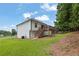 Grassy backyard with a deck, stairs, and mature trees offers ample space for outdoor entertaining at 4735 Julian Way, Acworth, GA 30101