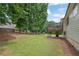 Large backyard features a spacious lawn, mature trees, and a deck, perfect for outdoor activities at 4735 Julian Way, Acworth, GA 30101