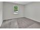 A basic bedroom with grey carpet and lots of light coming through the large window at 4735 Julian Way, Acworth, GA 30101