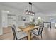 Light-filled dining area boasts vaulted ceilings, contemporary lighting, and views into the living space at 4735 Julian Way, Acworth, GA 30101