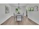 Bright dining room features a modern light fixture, wood floors, neutral paint and stylish decor at 4735 Julian Way, Acworth, GA 30101