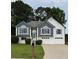 Inviting home featuring a two-car garage, manicured lawn, and charming architectural details at 4735 Julian Way, Acworth, GA 30101