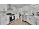 Well-lit kitchen boasts white cabinetry, stainless steel appliances, and quartz countertops at 4735 Julian Way, Acworth, GA 30101