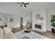 Inviting living room with fireplace, hardwood floors, vaulted ceiling, and a view of the kitchen at 4735 Julian Way, Acworth, GA 30101