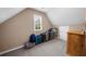 This attic features neutral walls, a carpeted floor, and a window for natural light at 7049 Bennington Ln, Cumming, GA 30041