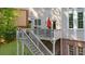 View of deck with outdoor grill and umbrella with stairs leading down to the yard at 7049 Bennington Ln, Cumming, GA 30041