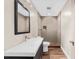 Modern bathroom with updated sink vanity and frameless glass shower door at 7049 Bennington Ln, Cumming, GA 30041