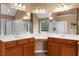 The bathroom features a double vanity, ample lighting, and a separate shower and tub at 7049 Bennington Ln, Cumming, GA 30041