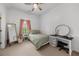 A well-lit bedroom boasts a desk, ample natural light, and a comfortable bed at 7049 Bennington Ln, Cumming, GA 30041