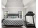 Spacious bedroom features tray ceiling, polka dot bedspread, and a treadmill for exercise at 7049 Bennington Ln, Cumming, GA 30041