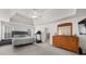 Bright bedroom with a tray ceiling, a treadmill, a polka dot bedspread, and lots of natural light at 7049 Bennington Ln, Cumming, GA 30041