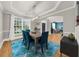 Bright dining room featuring hardwood floors, modern light fixture, and open layout at 7049 Bennington Ln, Cumming, GA 30041