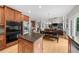 Open-concept kitchen with hardwood floors and direct view to dining and living areas at 7049 Bennington Ln, Cumming, GA 30041