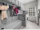 Convenient laundry room with built-in shelving, storage and a utility sink at 7049 Bennington Ln, Cumming, GA 30041