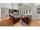 Open-concept living room boasts tall ceilings, a fireplace, custom cabinets, and a view to the second floor at 7049 Bennington Ln, Cumming, GA 30041