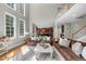 Bright living room with hardwood floors, lots of windows, and open view to the kitchen and second floor at 7049 Bennington Ln, Cumming, GA 30041