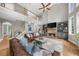 Inviting living room with a stone fireplace, hardwood floors, and lots of natural light at 7049 Bennington Ln, Cumming, GA 30041