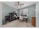 Light-filled office space with a ceiling fan, large windows, and neutral walls and carpet at 7049 Bennington Ln, Cumming, GA 30041