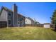 The large back yard is fully fenced and has a lush green lawn at 1932 Sawgrass Dr, Hampton, GA 30228