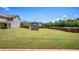 Expansive backyard featuring a level lawn, storage shed, and wooden fence, ideal for outdoor activities at 1932 Sawgrass Dr, Hampton, GA 30228