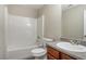The bathroom includes a shower-tub, granite countertop vanity and a comfort height toilet at 1932 Sawgrass Dr, Hampton, GA 30228