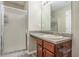 Functional bathroom featuring a shower, vanity with a sink, and wood cabinets at 1932 Sawgrass Dr, Hampton, GA 30228