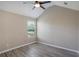 Cozy bedroom with neutral walls, ceiling fan, one window, and wood-look flooring at 1932 Sawgrass Dr, Hampton, GA 30228