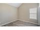 This bedroom features neutral walls, wood-look flooring and a bright window at 1932 Sawgrass Dr, Hampton, GA 30228