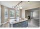 Open kitchen and breakfast nook with a unique island countertop and access to the living room at 1932 Sawgrass Dr, Hampton, GA 30228