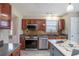 Well-lit kitchen featuring stainless steel appliances, a decorative backsplash and a striking island countertop at 1932 Sawgrass Dr, Hampton, GA 30228