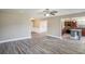 Open floor plan features hardwood floors connecting the living area to the kitchen with stainless steel appliances at 1932 Sawgrass Dr, Hampton, GA 30228