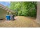 Backyard featuring a small patio, lawn, mature trees, and woods at 2557 Woodford Ln, Buford, GA 30519
