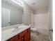 Bathroom featuring a single vanity, mirror, toilet, and tub-shower combination at 2557 Woodford Ln, Buford, GA 30519