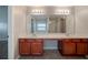 Modern bathroom with double vanity, and a large mirror at 2557 Woodford Ln, Buford, GA 30519