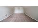 Bedroom with two closet doors, neutral walls, trim, and carpeting at 2557 Woodford Ln, Buford, GA 30519