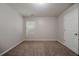 Bedroom with a door, window, neutral walls, trim, and carpeting at 2557 Woodford Ln, Buford, GA 30519